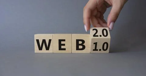 WEB 2 or 1 symbol. Businessman hand Turnes cube and changes word WEB 1.0 to W 库存照片