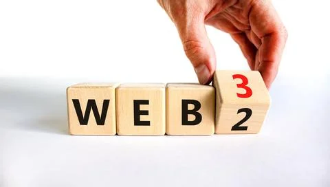 WEB 2 or 3 symbol. Businessman turns a wooden cube and changes words WEB 2 to 库存照片