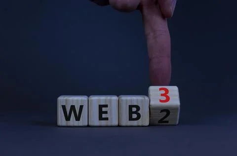 WEB 2 or 3 symbol. Businessman turns a wooden cube and changes words WEB 2 to Photos