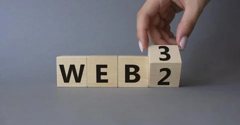 Web 3 vs Web 2 symbol. Businessman Hand turns cubes and changes the word we.. Photos