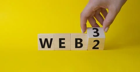 Web 3 vs Web 2 symbol. Businessman Hand turns cubes and changes the word we.. Photos