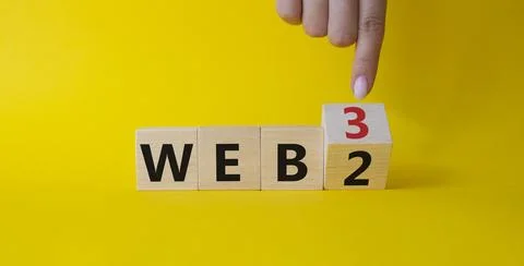 Web 3 vs Web 2 symbol. Businessman Hand points at turned wooden cubes with .. Stock Photos