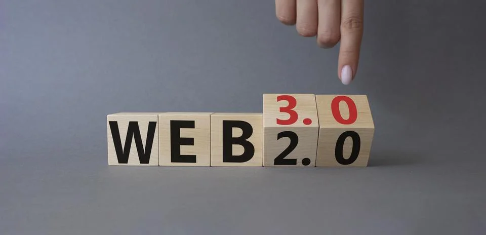 Web 3.0 vs Web 2.0 symbol. Finger points at cubes with the words web 3.0 an.. Stockfoto's