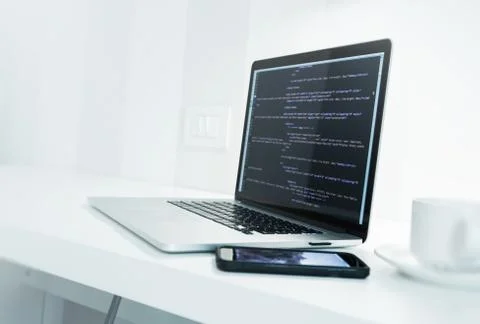 Web Application Developer Desk with Modern Laptop Computer and Website Source Stock Photos