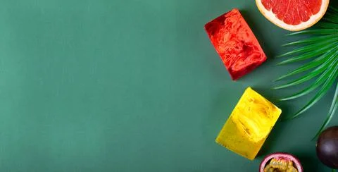 Web banner with bars of soap of red and yellow colors on green Stock Photos