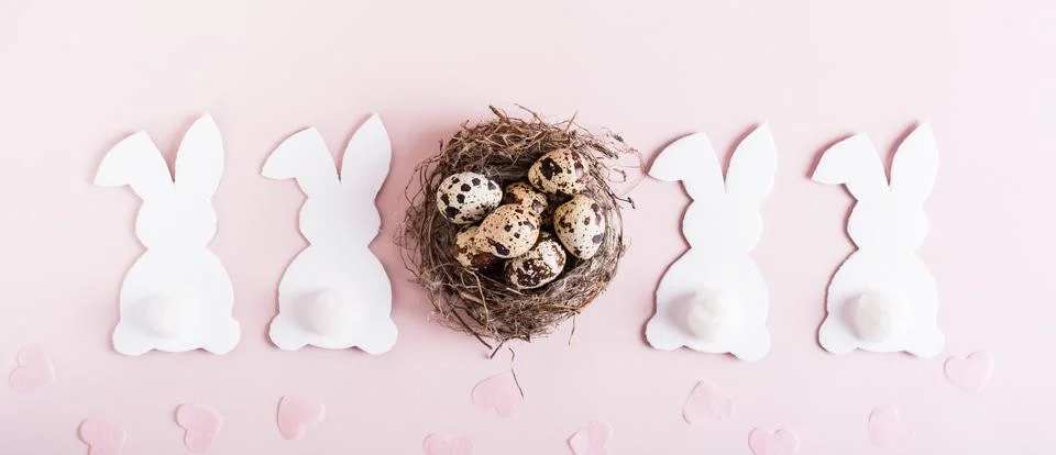 Web banner happy easter white rabbits, nest with eggs and hearts on pink ba.. Stock Photos
