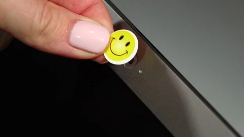 Web camera shut off by funny smiley sticker, fear of malicious software concept Stock Footage 69879472