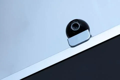 A web camera for video recording and surveillance is on the monitor. Equipmen Stock Photos