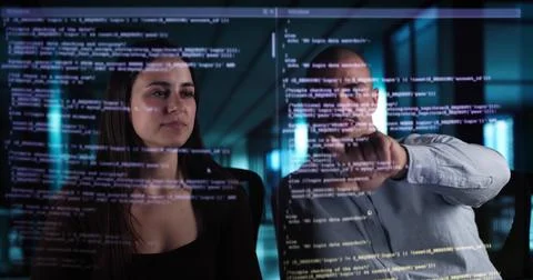 Web Coders Using Online Software On Futuristic Transparent Screen Interfaces. Stock Photos