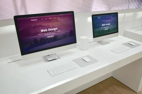 Web design development studio with two monitors and web site presentations. Stock Photos