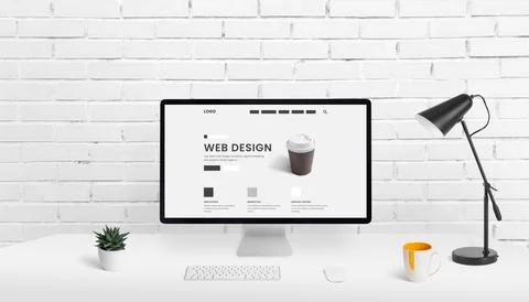 Web design studio composition with computer display and concept web page on w Stock Photos