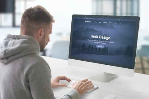 Web design studio concept with man and computer display with modern web site  Stock Photos