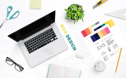 Web design studio desk with laptop computer and color palette. Top view, flat Stock Photos