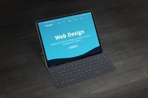 Web design studio promo web site on tablet with keyboard on office desk. Resp Stock Photos