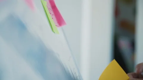 Web designer attach sticker on special board in office Video stock 119462321