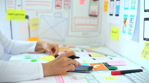 Web designer is developing an application for mobile phones.  Video stock 115971732