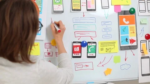 A web designer is developing a user interface for mobile phone applications.  Video stock 122389427