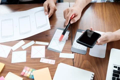 Web designer planning application for mobile phone 스톡 사진