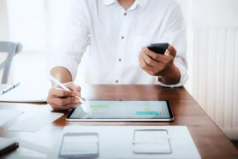 Web designer, UX UI designer designing mobile application user interface. Stock Photos