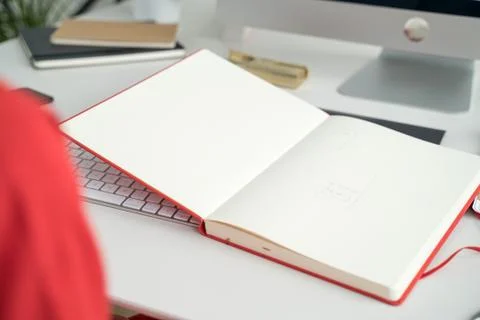 Web designer at work. Graphic designer. Girl in red dress with red sketchbook Stock Photos