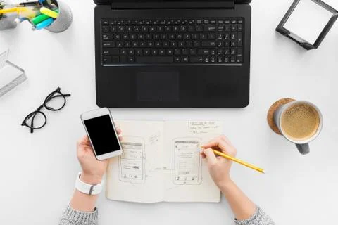 Web designer working on smartphone user interface 스톡 사진