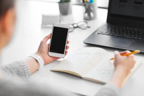 Web designer working on smartphone user interface Stock Photos
