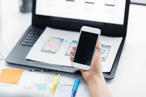 Web designer working on smartphone user interface Stock Photos