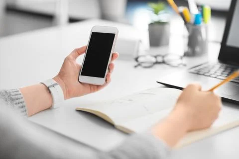 Web designer working on smartphone user interface 写真素材