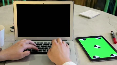 Web designer working on website layout on laptop and tablet Stock Footage 62802571