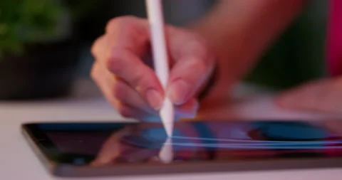 Web designer works on upcoming comics on tablet touchscreen Stock Footage 221728202