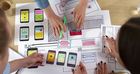 Web designers are developing a smartphone interface.  Stock Footage 201747094