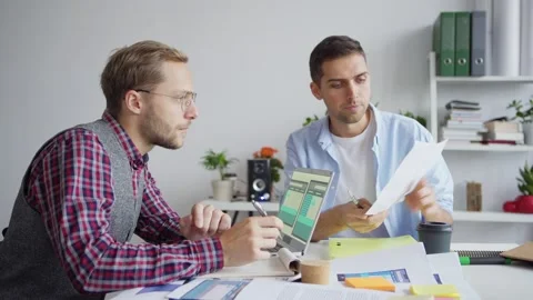 Web designers discussing application interface samples Stock Footage 142527303