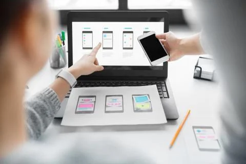 Web designers work on smartphone user interface Stockfoto's