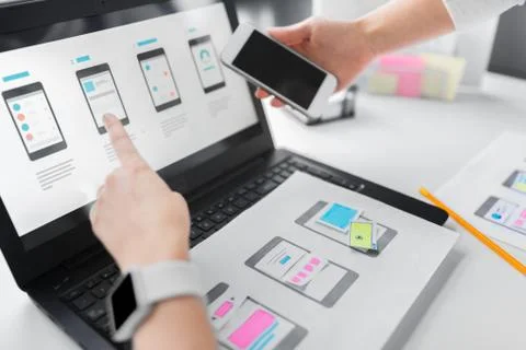 Web designers work on smartphone user interface 스톡 사진