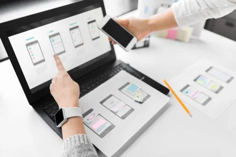 Web designers work on smartphone user interface 스톡 사진