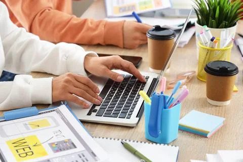 Web designers working at desk in office, closeup Stock Photos
