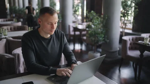 Web-Developer And IT Professional Man Working Remotely, Sitting With Laptop In Stock Footage 247734311