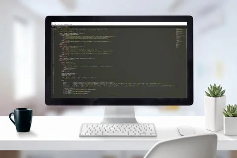 Web developer computer with javascript code on display. Work desk close-up sc Stock Photos