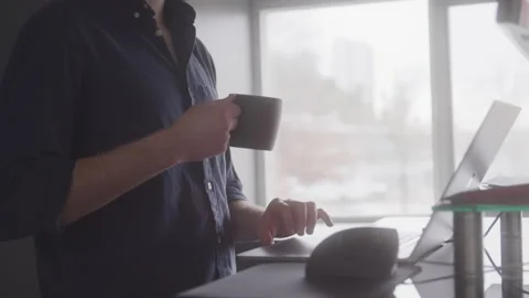 Web Developer with a Cup of Coffee Typing Code on His Laptop Stock Footage 208785326