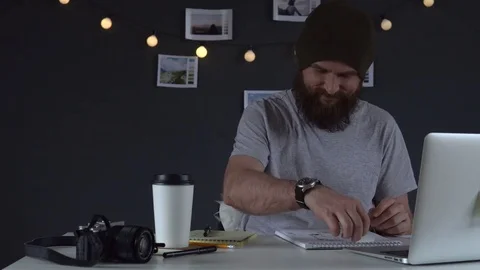 Web developer drinking coffee and working on the computer at home Stock Footage 83782561