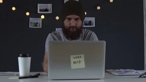 Web developer drinking coffee and working on the computer at home Stock Footage 83782903