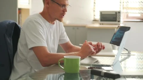 Web developer explains project via video call, suggesting improvements. Stock Footage 294299314
