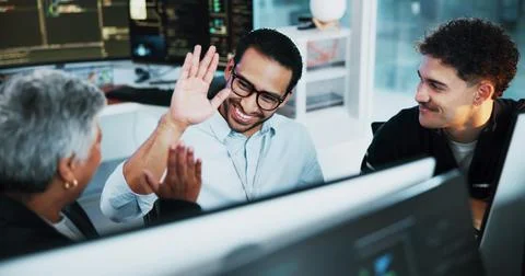 Web developer, high five and celebration in office for software, system or Stock Photos