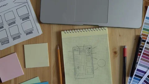 The web developer makes the layout of the website on his notebook. Stock Footage 83781997