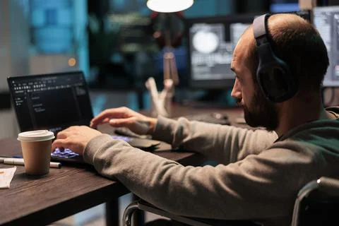 Web developer with physical disability writing code 스톡 사진