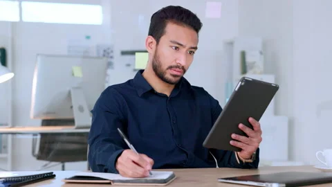 Web developer reading digital tablet, writing notes and thinking of design for Video stock 201907028