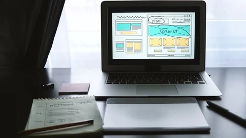 Web developer sitting at the table making a sketch of the future site. Working Stock Footage 87880655