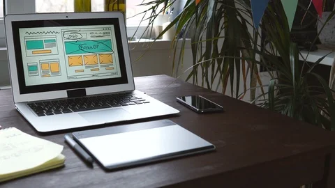 Web developer sitting at the table making a sketch of the future site. Working Video stock 87880968