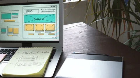 Web developer sitting at the table making a sketch of the future site. Working Video stock 87881092