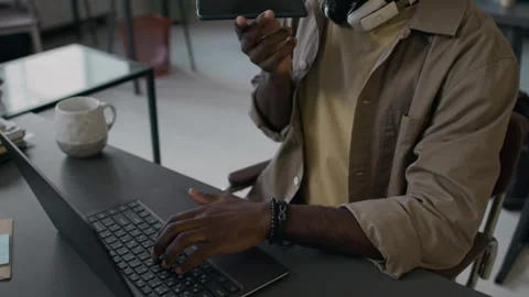 Web Developer Speaking on Phone with Colleague while Coding on Laptop Stock Footage 299235819